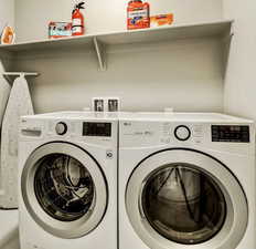 Washroom with washing machine and clothes dryer