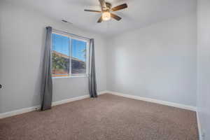 Unfurnished room with ceiling fan and carpet flooring