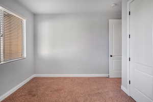 Empty room featuring carpet flooring