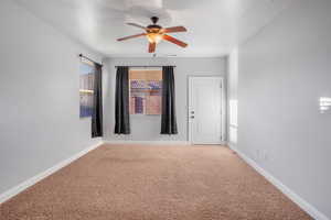 Spare room with ceiling fan and carpet