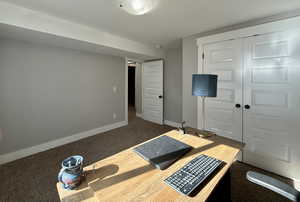 Exercise room featuring dark colored carpet