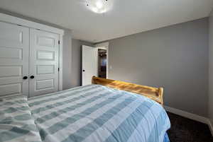 Carpeted bedroom with a closet