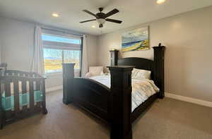 Bedroom with ceiling fan and carpet floors