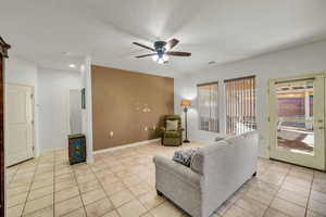 Tiled living room featuring ceiling fan