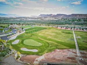 View of home's community golf course  featuring a mountain view