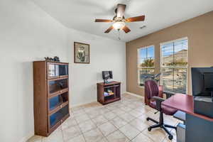 Office with ceiling fan and light tile patterned floors