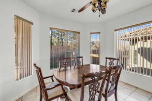 Dining room with ceiling fan and light tile patterned floors