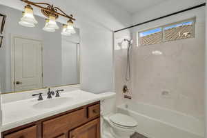 Full bathroom with toilet, bathing tub / shower combination, and vanity