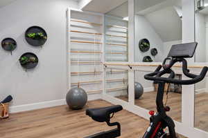 Workout area with hardwood / wood-style flooring