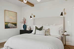 Bedroom featuring dark hardwood / wood-style floors and beamed ceiling