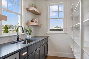 Kitchen with backsplash, plenty of natural light, and sink