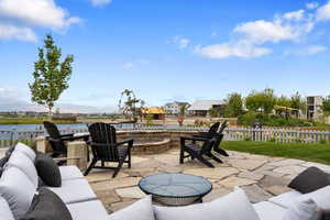 View of patio / terrace with a water and mountain view and an outdoor living space