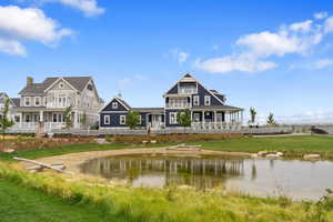 Exterior space with a water view and a yard