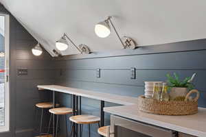 Interior space featuring lofted ceiling and wine cooler