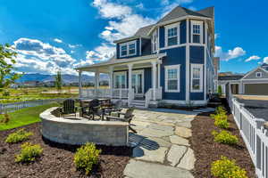 Rear view of house with a mountain view, a patio area, and a porch