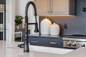 Interior details with backsplash, light brown cabinets, and oven