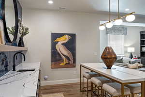 Dining space with dark hardwood / wood-style floors and sink