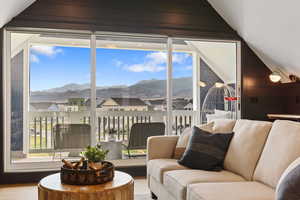 Living room featuring lofted ceiling, a mountain view, and hardwood / wood-style floors