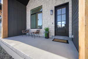 View of exterior entry featuring covered porch