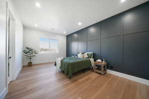 Bedroom with light hardwood / wood-style flooring