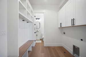 Mudroom with sink and light hardwood / wood-style flooring