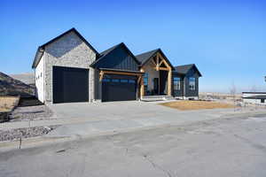 Modern farmhouse style home with a garage and a mountain view