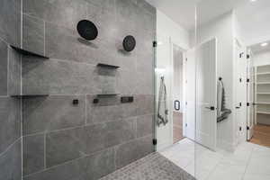 Bathroom featuring a shower with door