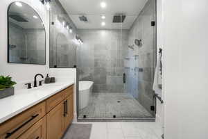 Bathroom with independent shower and bath, tile patterned floors, and vanity