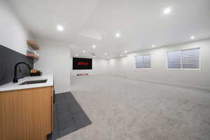 Interior space featuring dark carpet and sink