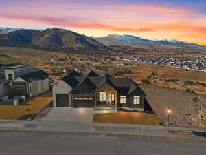 View of front of property with a garage and a mountain view