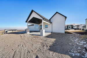 Back of property with a patio