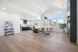 Living room featuring light hardwood / wood-style flooring and high vaulted ceiling