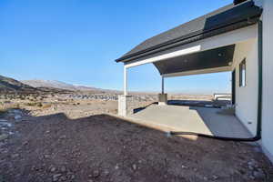 View of yard featuring a mountain view and a patio