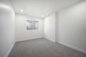 Unfurnished room featuring carpet