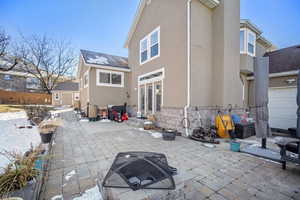 Back of property featuring a patio area, an outdoor fire pit, and a storage unit