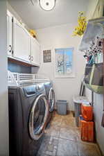 Clothes washing area with cabinets and washing machine and clothes dryer