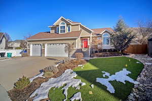 View of front property with a garage and a front yard