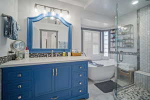 Bathroom with independent shower and bath, decorative backsplash, and vanity