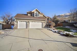 View of front of property featuring a mountain view and a garage