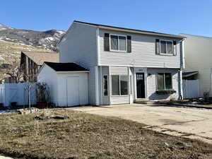 Rear view of house featuring a mountain view and a patio