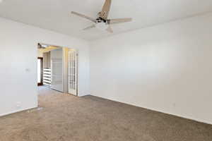 Primary bedroom with carpet floors, a textured ceiling, and ceiling fan