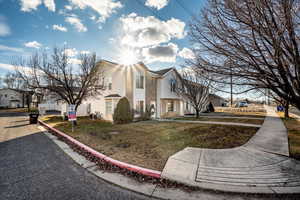 View of side of home with a yard