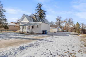 View of snow covered back of property