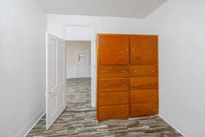 Unfurnished bedroom with a closet and dark hardwood / wood-style floors