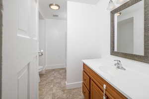 Bathroom featuring vanity and toilet