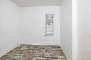 Bedroom with dark hardwood / wood-style flooring