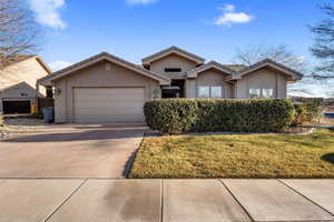 View of front of home with a garage and a front yard