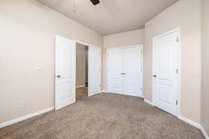 Unfurnished bedroom featuring ceiling fan and carpet flooring