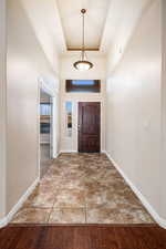 Foyer with a towering ceiling and a raised ceiling