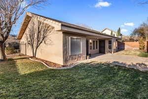 Back of house featuring a yard and a patio